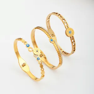 Drie elegante goudkleurige titanium stalen armbanden met blauw oogmotief en kristallen