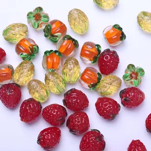 Detailed macro view of colorful fruit-shaped lampwork glass beads for jewelry DIY