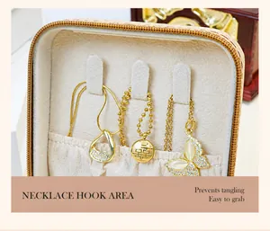 Macro view showing necklace hooks and pendants inside a beige fabric jewelry box
