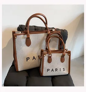 Large and small canvas tote bags featuring PARIS print and stylish brown leather trim