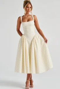 Full view of French style yellow gingham dress with square neck and pleated skirt