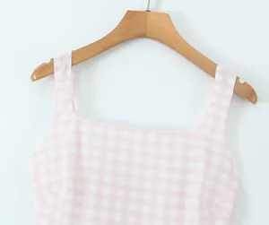 Close-up of the pink plaid dress featuring a square neckline and shoulder straps