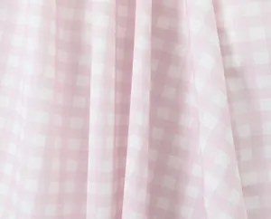 Close-up detail of the pink and white gingham fabric texture for summer dress.