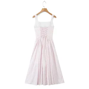 Close-up view of a pink gingham midi dress featuring a square neck and lace-up back