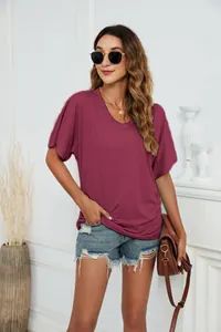 Close-up detail of women's summer casual loose V-neck t-shirt in solid burgundy cotton fabric