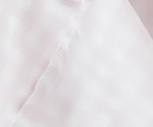 Close-up of fine stitching and pink checkered fabric texture for a summer dress