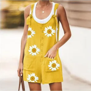Detail view of yellow sunflower print romper with functional patch pockets and buttons