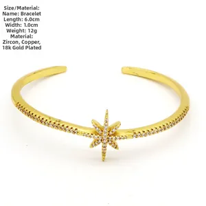 Detail view of 18k gold plated open cuff bracelet with pavé-set star design detail