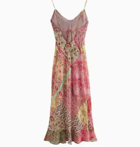Back view of a chic patchwork printed backless slip dress with thin spaghetti straps.