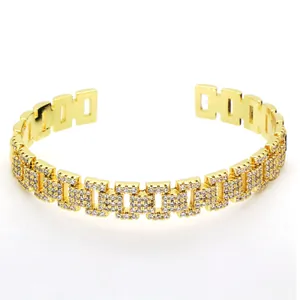 Close-up detailed view of a luxury gold iced-out geometric link open cuff bracelet for women