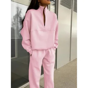 Tuta sportiva rosa da donna in due pezzi con felpa a mezza zip e pantaloni sportivi