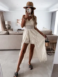 Elegant white lace romper featuring a high-low skirt overlay for a chic summer vacation look