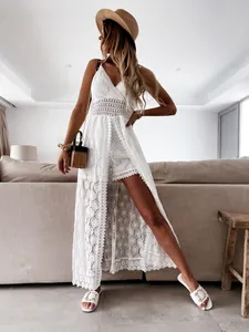 Elegant white lace romper with a long skirt overlay, perfect for a bohemian vacation look