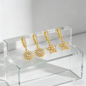 Gold-plated sunflower and floral hoop earrings with sparkling cubic zirconia stones.