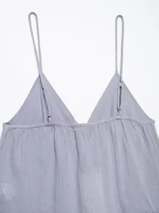 Close-up detail of grey V-neck camisole top showing fabric texture and adjustable straps.