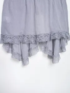 Close-up detail of elegant lavender lace embroidered hem on lightweight summer top.