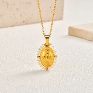 Close-up of vintage stainless steel gold necklace with pearl-embellished oval Mary pendant