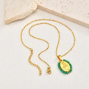 Vintage gold plated stainless steel necklace featuring green beaded oval Virgin Mary pendant