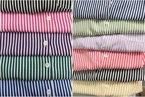 Close-up display showing a collection of colorful vertical striped long sleeve shirts