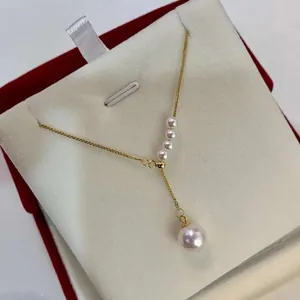Close-up of elegant Y-shaped gold chain necklace with 8-9mm round freshwater pearls