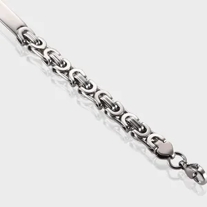 Detailed macro view of silver Byzantine chain link bracelet with curved stainless steel ID tag