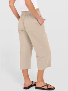 Women's beige cotton linen wide-leg cropped pants with elastic waist and pockets.