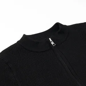 Vista dettagliata di un body in maglia a costine nera con scollo a mezza zip argento