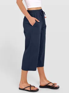 Detailed side view of navy blue cotton linen wide-leg pants with drawstring waist and pockets