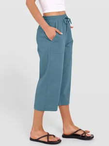 Side view of women's solid color linen cotton drawstring wide-leg pants with pockets