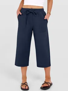 Detail view of navy blue wide-leg cotton linen drawstring casual pants for women.