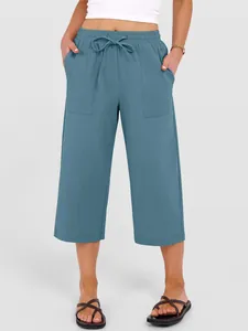 Detail of blue cotton linen culottes featuring drawstring waist and large pockets