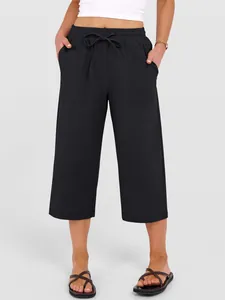 Detail view of black cotton linen wide leg drawstring casual pants with patch pockets.
