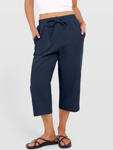 Detailed view of navy blue cotton linen wide-leg drawstring pants on a model