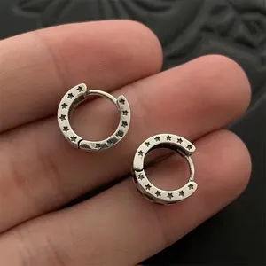 Close-up of S925 silver hoop earrings with star engravings and checkered pattern