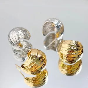 Detailed close-up of geometric hammered finish 18K gold and silver plated stud earrings set