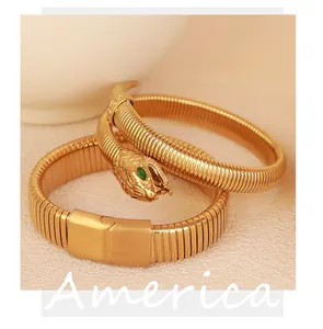 Close-up of golden elastic snake bracelet set with green zircon eyes decoration