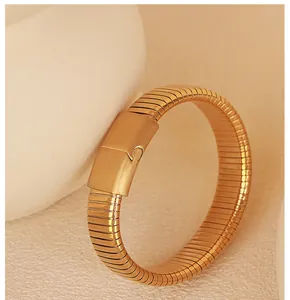 Close-up of golden elastic snake bracelet showing the unique tubogas scale texture