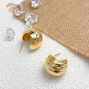 Detailed close-up of 18K gold-plated earrings featuring a unique hammered texture design