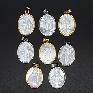 Detailed view of religious pendants carved in natural mother-of-pearl shell with metal frames