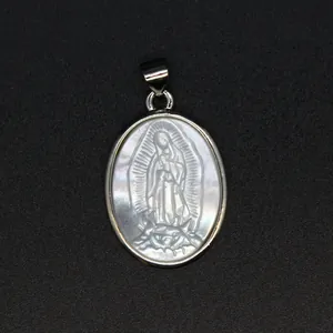 Close-up of a religious Lady of Guadalupe carving on natural white mother-of-pearl pendant