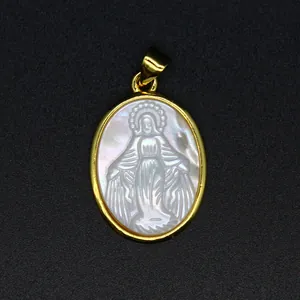 Macro detail of natural mother of pearl pendant featuring a carved Virgin Mary icon