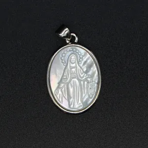Detailed view of oval natural mother of pearl pendant with carved Virgin Mary icon.