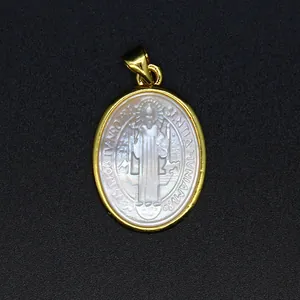 Detailed macro shot of a carved white mother-of-pearl religious saint pendant necklace