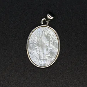 Detailed macro view of a vintage religious saint carving on a natural mother of pearl shell