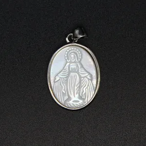 Detailed close-up of natural white mother of pearl carved Virgin Mary pendant jewelry