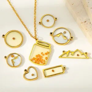 Detail showing various stainless steel mustard seed pendants in heart and jar shapes