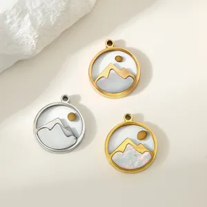 Close-up of circular stainless steel mountain pendants featuring a mustard seed sun detail
