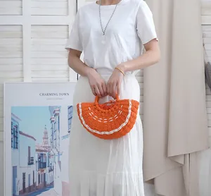 Primer plano de un bolso de paja naranja con forma de sandía para las vacaciones