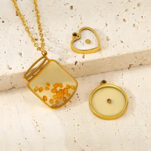 Detail view of stainless steel mustard seed pendants in heart, round and jar shapes