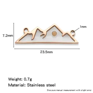 Rose gold stainless steel mountain pendant charm featuring a small real mustard seed